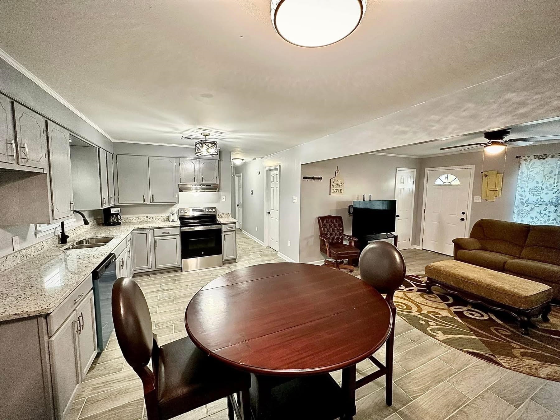 2003 Bond Ferry Road Brownsville, TN 38012 - Photo 4 of 21 Dining area with wood finish floors, healthy amount of natural light, crown molding, and a ceiling fan