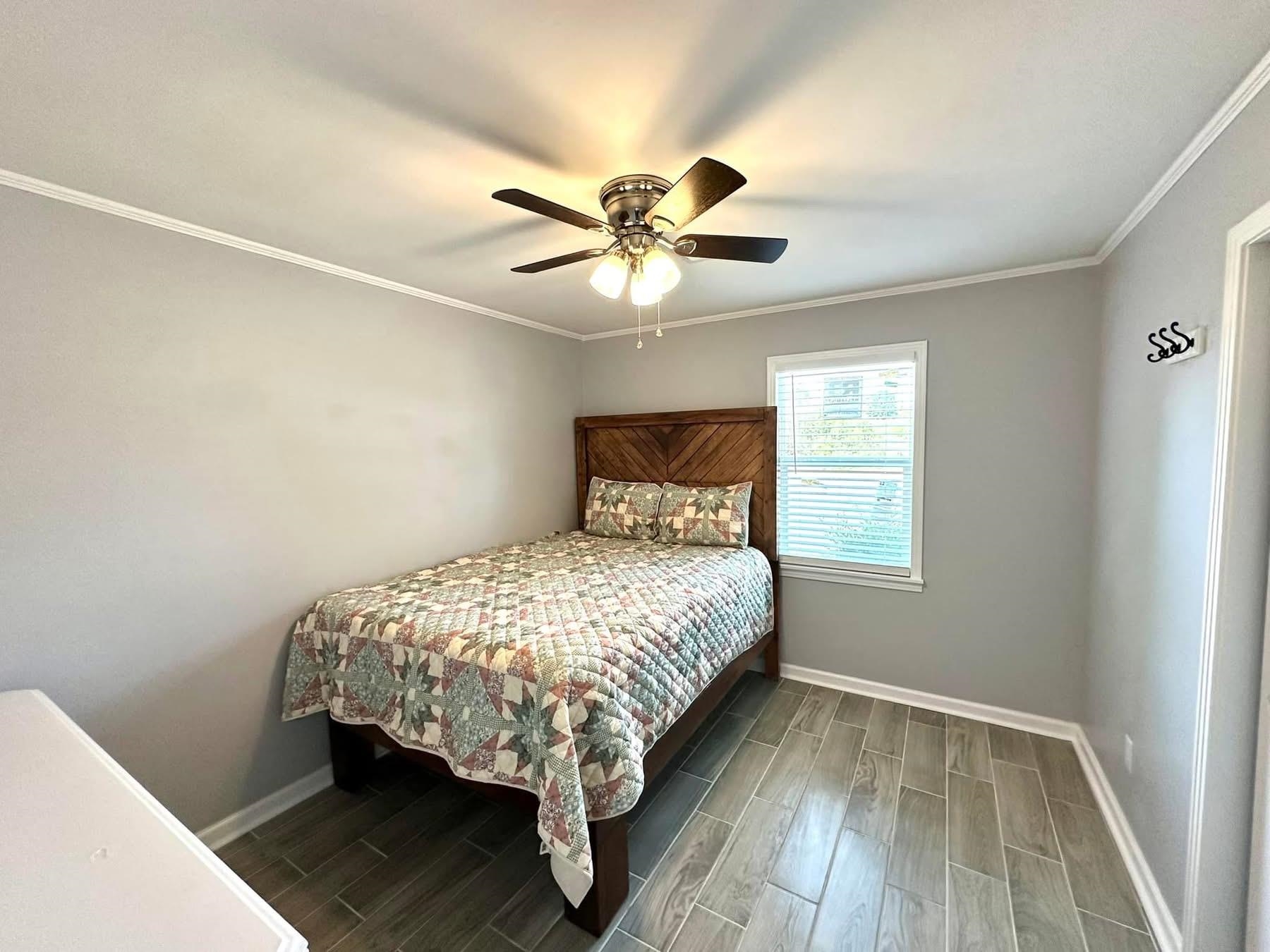 2003 Bond Ferry Road Brownsville, TN 38012 - Photo 7 of 21 Bedroom with wood tiled floors, ornamental molding, and a ceiling fan