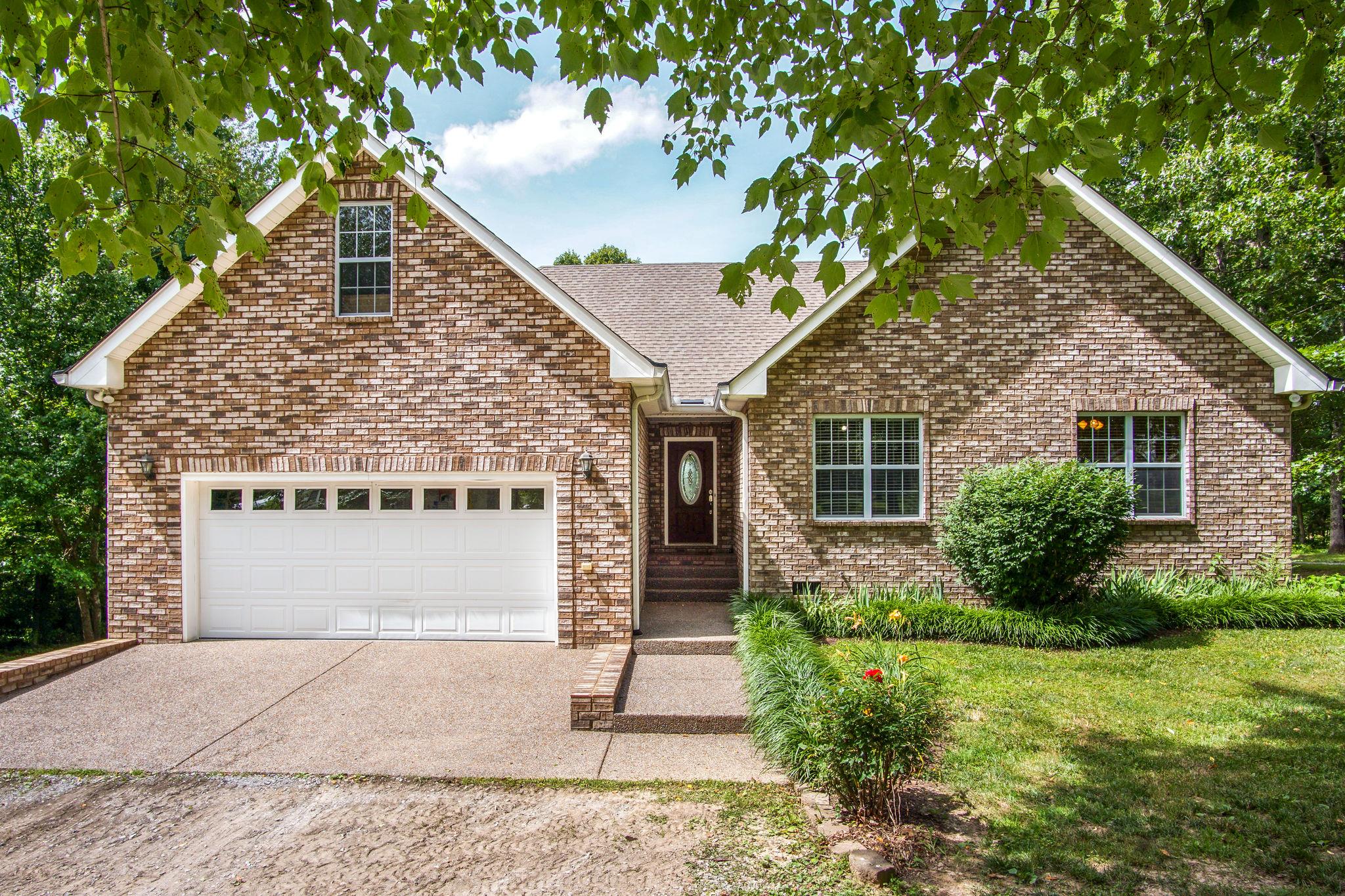 1674 Eno Road Dickson, TN 37055 - Photo 1 of 28 a front view of a house with garden