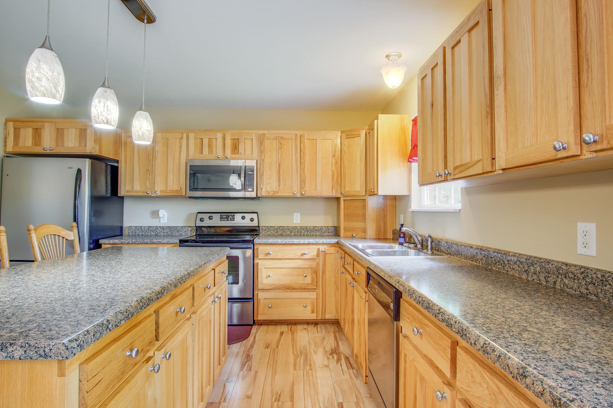 1674 Eno Road Dickson, TN 37055 - Photo 10 of 28 a kitchen with granite countertop a sink a counter space appliances and cabinets
