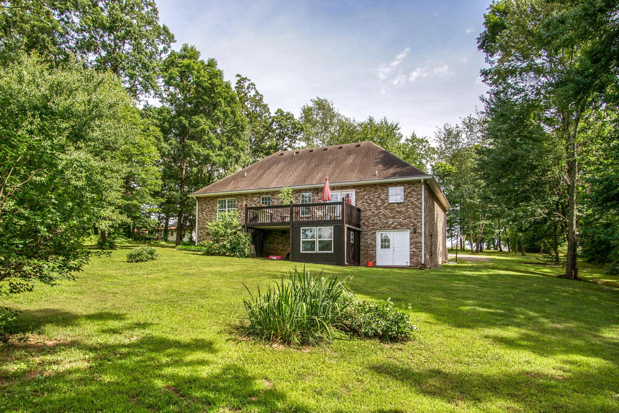 1674 Eno Road Dickson, TN 37055 - Photo 3 of 28 a view of a house with a big yard and large trees
