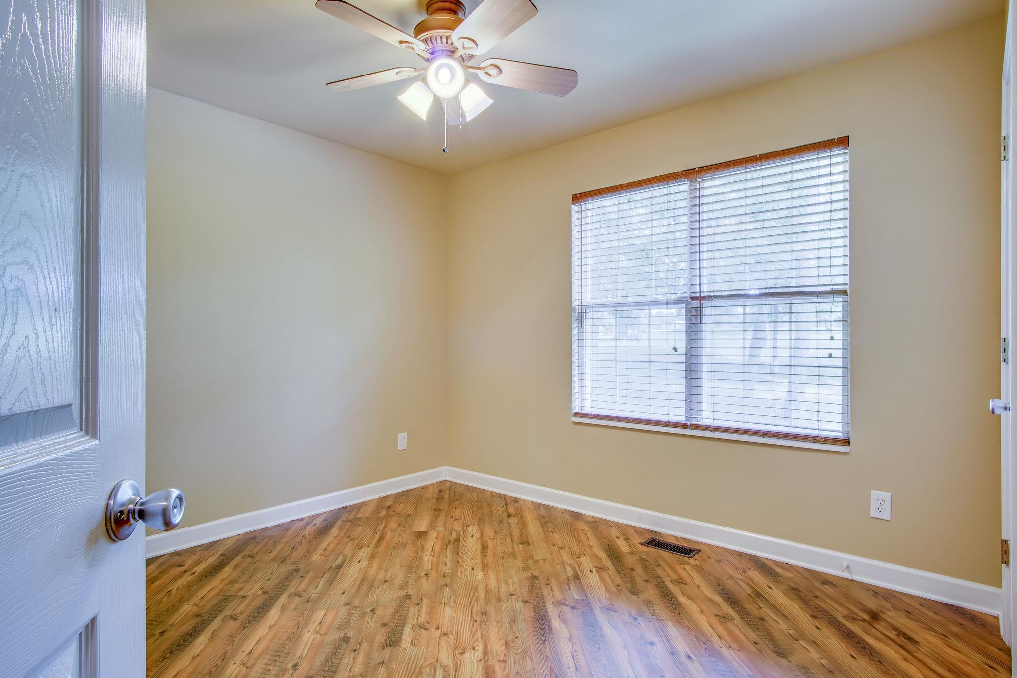 1674 Eno Road Dickson, TN 37055 - Photo 21 of 28 a view of an empty room with wooden floor and a window