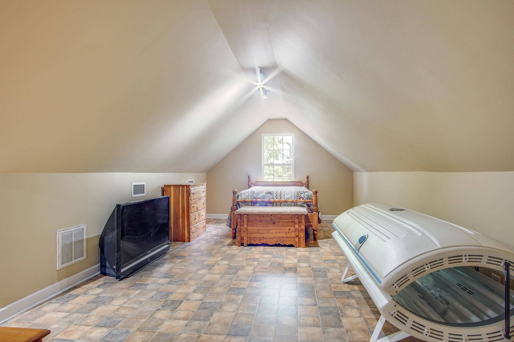 1674 Eno Road Dickson, TN 37055 - Photo 24 of 28 a bedroom with a bed and a chandelier