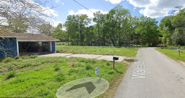 a view of a house with a yard and a park