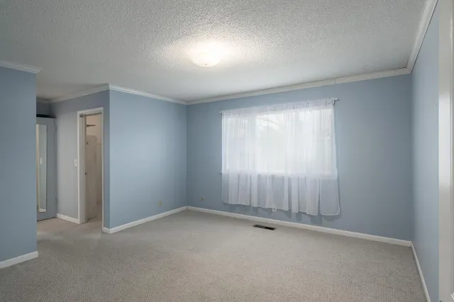 an empty room with a empty space and windows