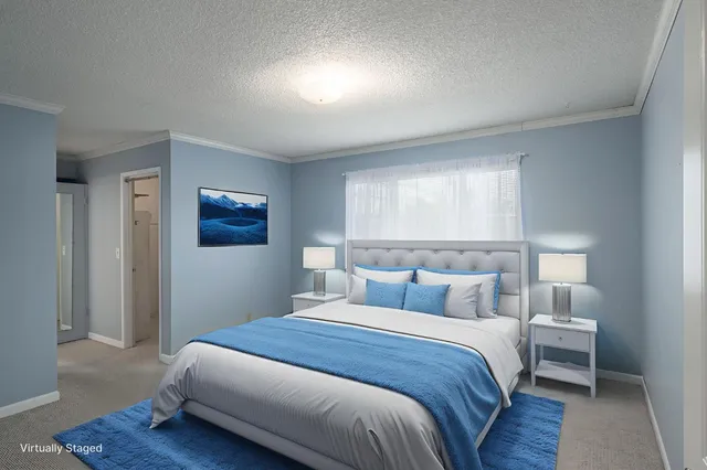 a bedroom with a bed and a night stand