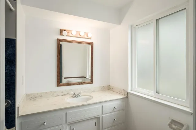 a bathroom with a sink and a mirror