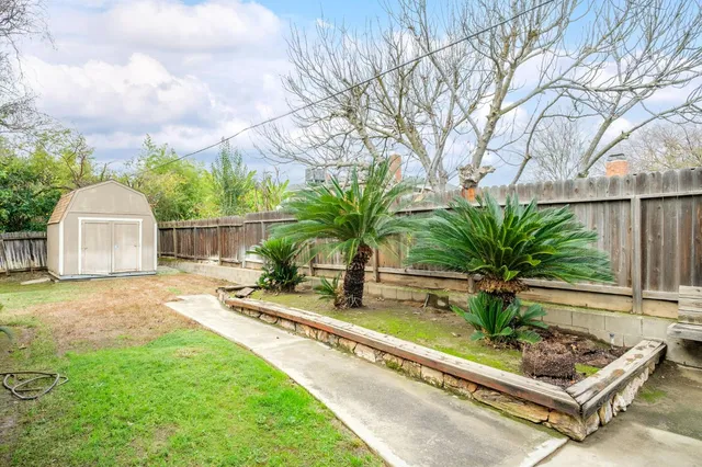 a view of a backyard with sitting area