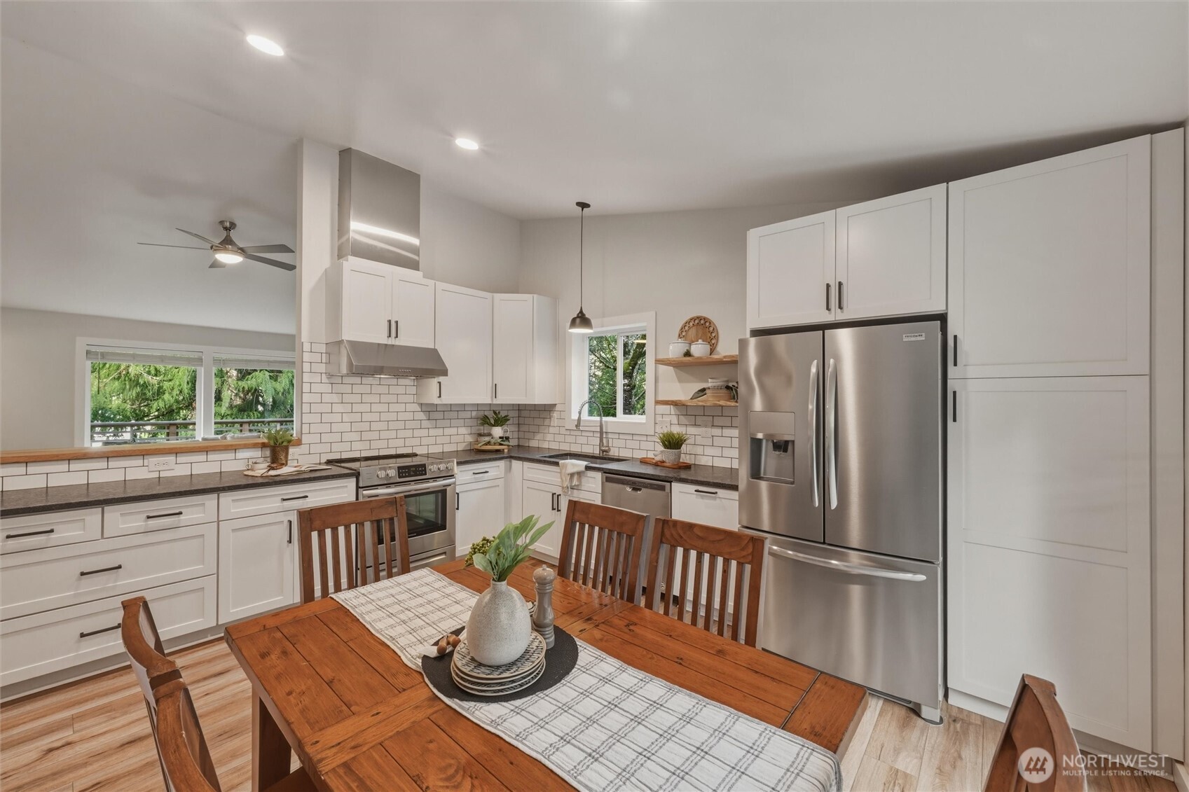 9 Sunnyside Lane Bellingham, WA 98229 - Photo 13 of 39 a kitchen with stainless steel appliances a refrigerator a stove a sink a dining table and chairs