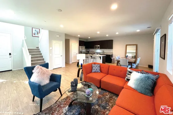 a view of a hallway with furniture and stairs