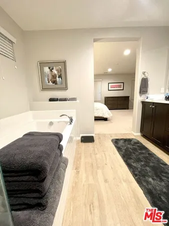 a spacious bathroom with a sink and a mirror