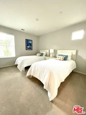 a spacious bedroom with two beds and a couch