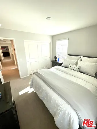 a living room with furniture kitchen view and a window