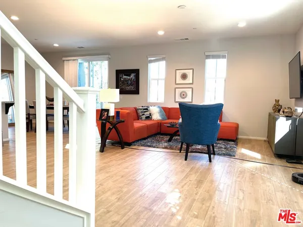 a living room with furniture fireplace and kitchen view