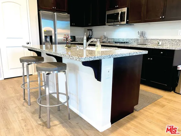 a kitchen with a dining table and chairs