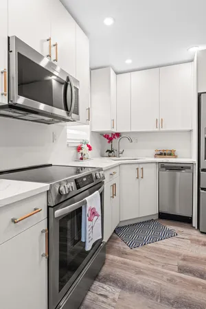 a kitchen with a stove a sink and a microwave