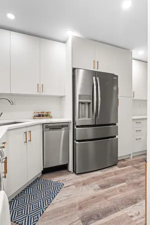 a kitchen with a refrigerator and a stove top oven
