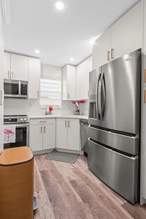 a kitchen with stainless steel appliances a refrigerator sink and microwave