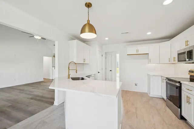 a spacious bathroom with a double vanity sink toilet mirror and shower
