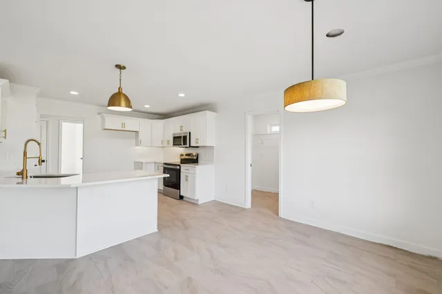 a bathroom with a sink a toilet a shower and a mirror