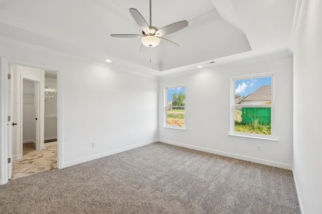 a front view of a house with a garden and garage
