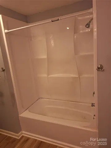 a view of bedroom with wooden floor and chair