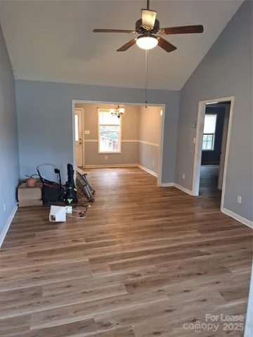 a view of a room with a window and wooden floor