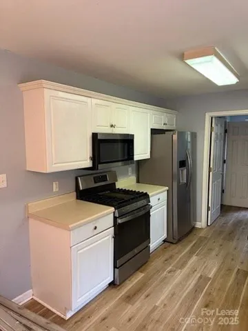 a kitchen with a sink stove and refrigerator