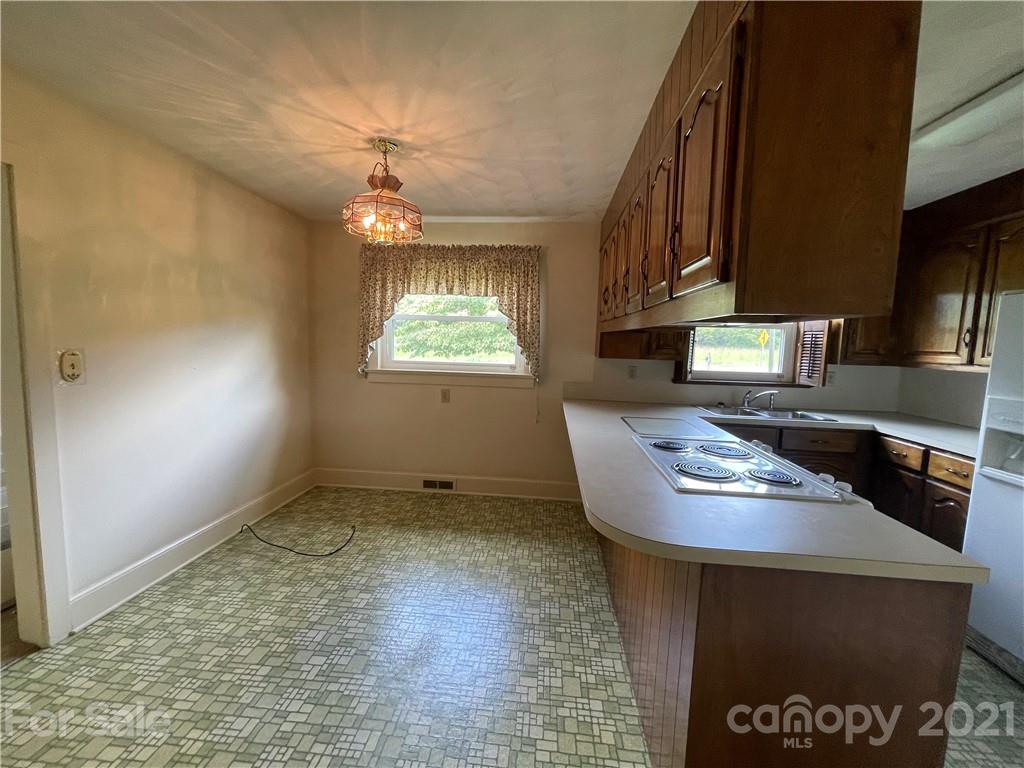 3096 Deal Mill Road Hudson, NC 28638 - Photo 14 of 25 wooden floor in an empty room with a fireplace