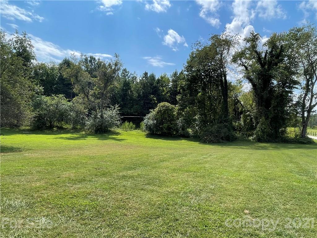 3096 Deal Mill Road Hudson, NC 28638 - Photo 5 of 25 a view of a field of grass and trees