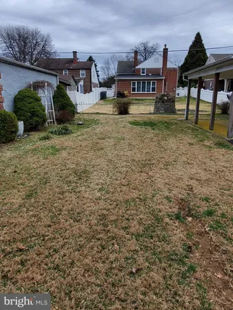 a backyard of a house with wooden fence