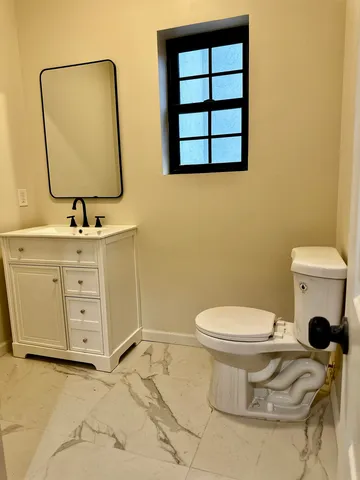 a bathroom with a sink a toilet and mirror