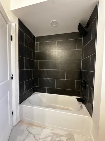 a bathroom with a bathtub and a shower