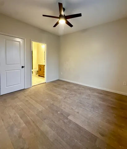 a view of empty room with ceiling fan