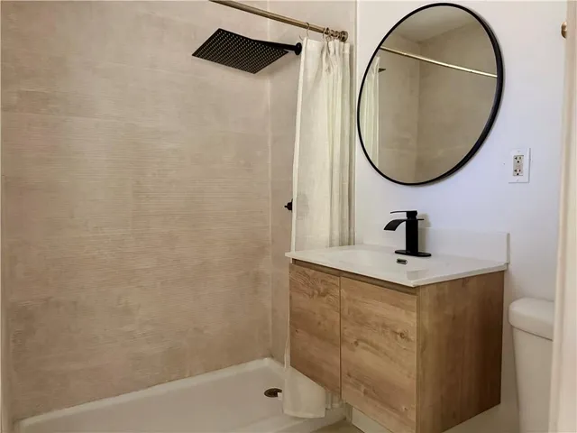 a bathroom with a sink a mirror and a shower