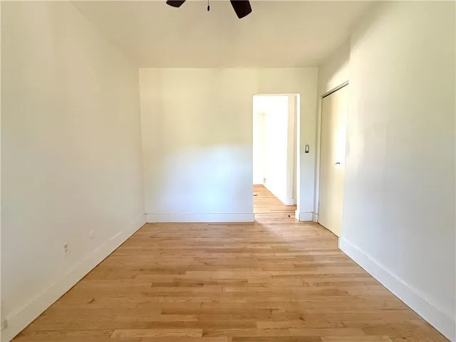 a view of a room with wooden floor