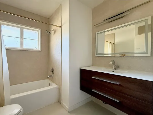 a bathroom with a bathtub and a sink