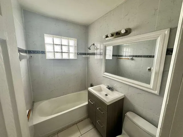 a bathroom with a bathtub sink and toilet