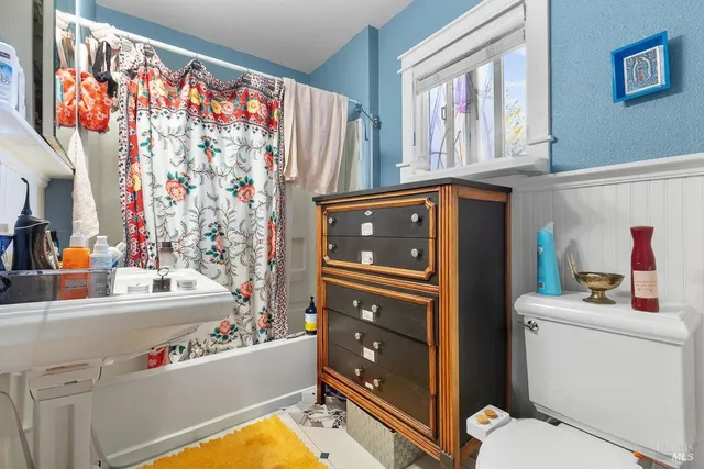 a sign board with buildings in the background