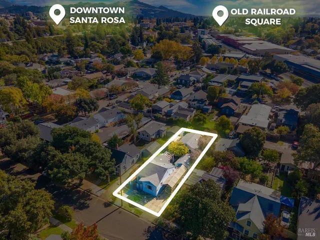 an aerial view of residential houses with outdoor space