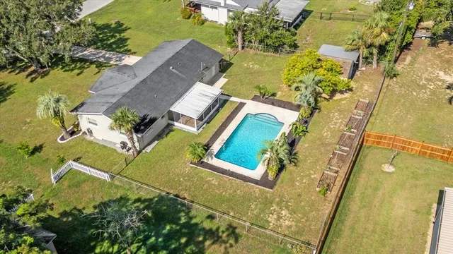 an aerial view of a residential houses with swimming pool