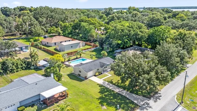 an aerial view of a house with a yard and outdoor seating