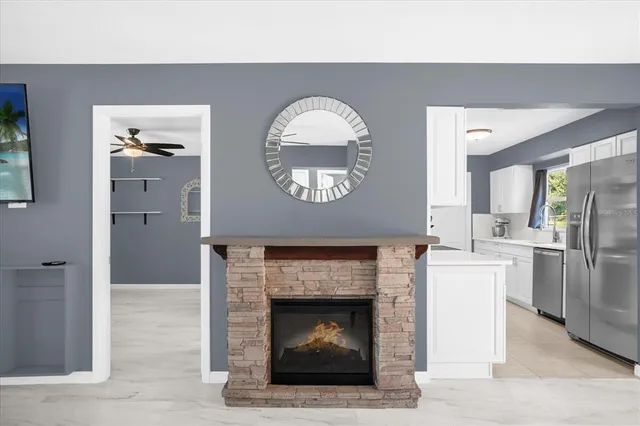 a living room with a fireplace furniture a rug and a window