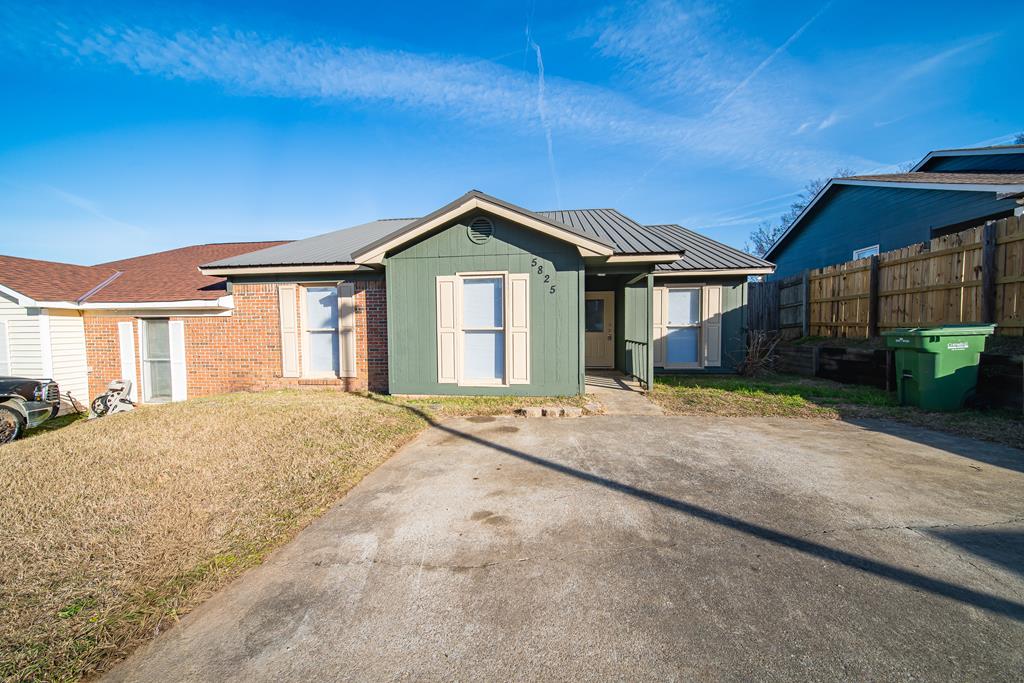 5825 Stafford Lane Columbus, GA 31907 - Photo 1 of 33 a front view of a house with a garden and patio