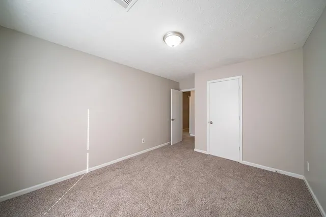 a view of an empty room and entryway