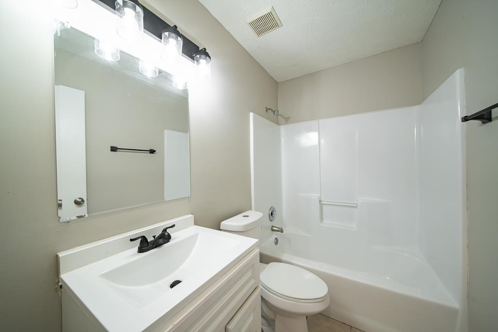 5825 Stafford Lane Columbus, GA 31907 - Photo 16 of 33 a bathroom with a sink toilet tub and shower