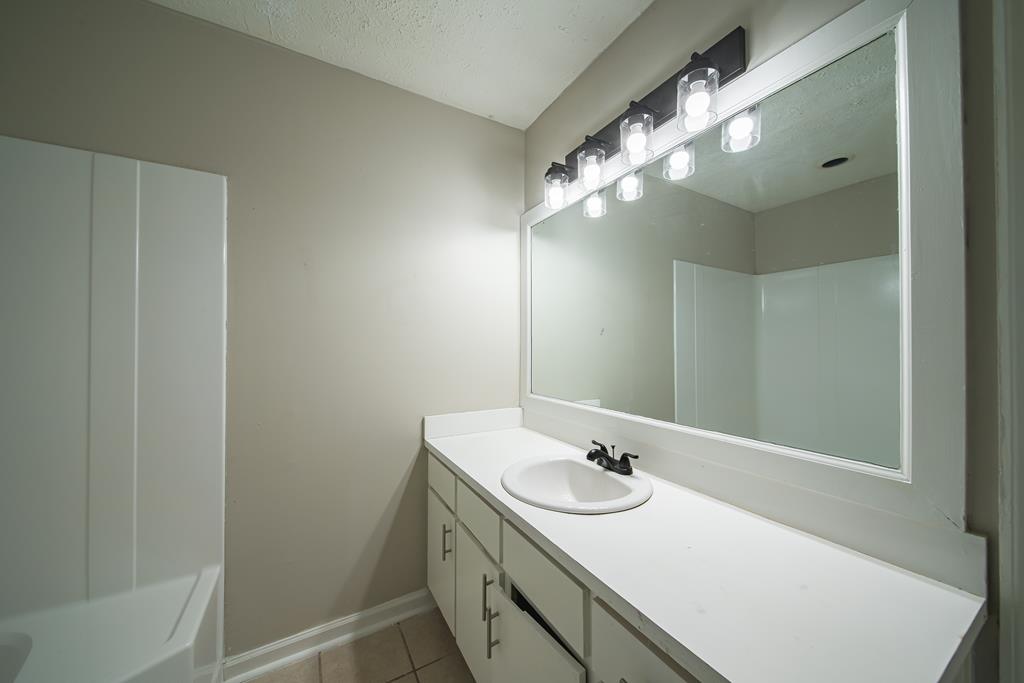 5825 Stafford Lane Columbus, GA 31907 - Photo 23 of 33 a bathroom with a sink and a mirror