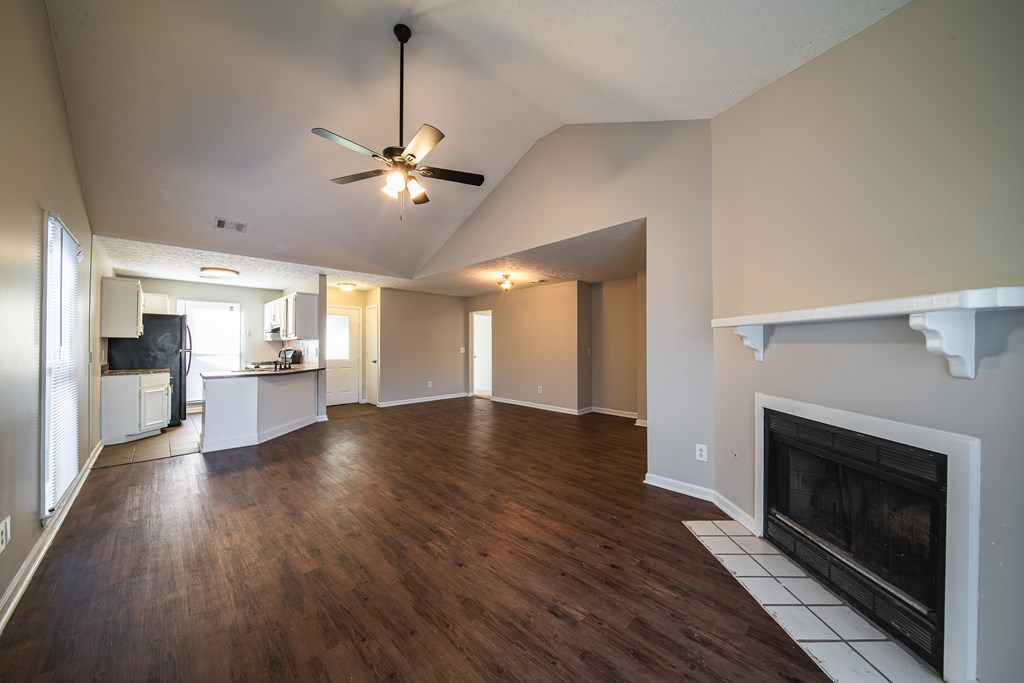 5825 Stafford Lane Columbus, GA 31907 - Photo 6 of 33 a view of a kitchen and an empty room with a fireplace