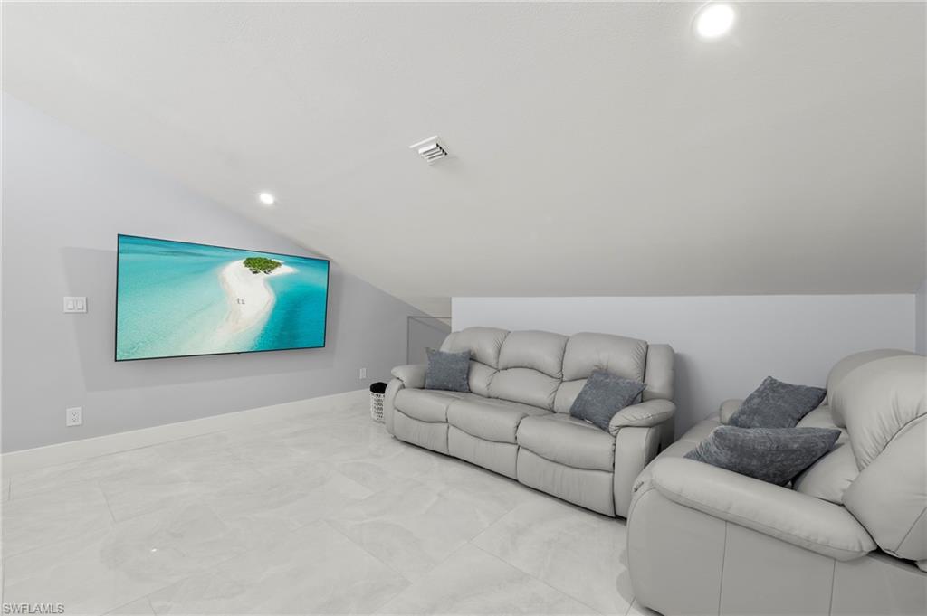 8765 Lateen Lane, Unit 203 Fort Myers, FL 33919 - Photo 15 of 28 a living room with furniture and a flat screen tv