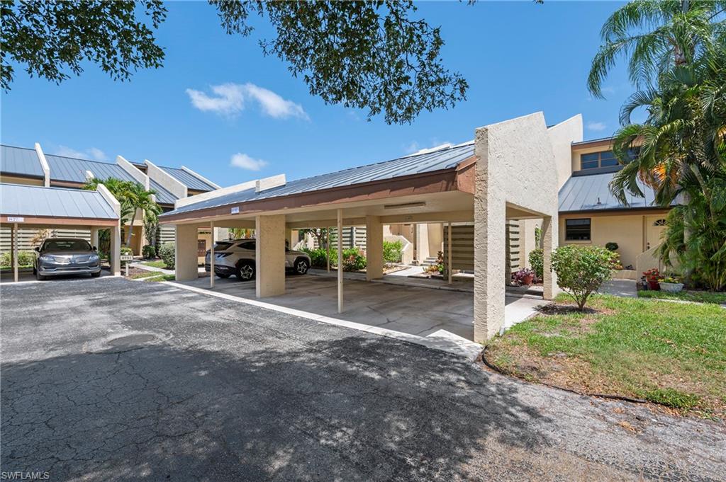 8765 Lateen Lane, Unit 203 Fort Myers, FL 33919 - Photo 17 of 28 a view of a car park in front of house